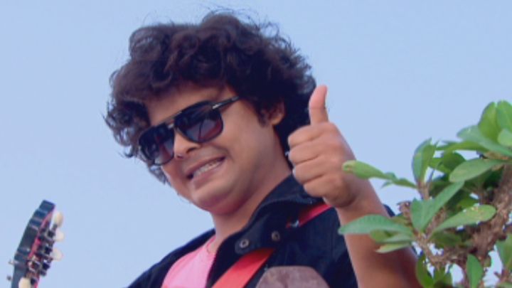 Kapi Pretends To Play The Guitar